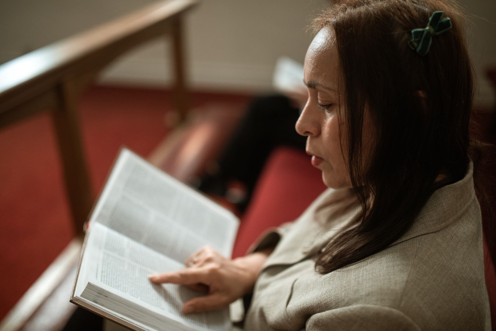 A woman reading her Bible in soft daylight