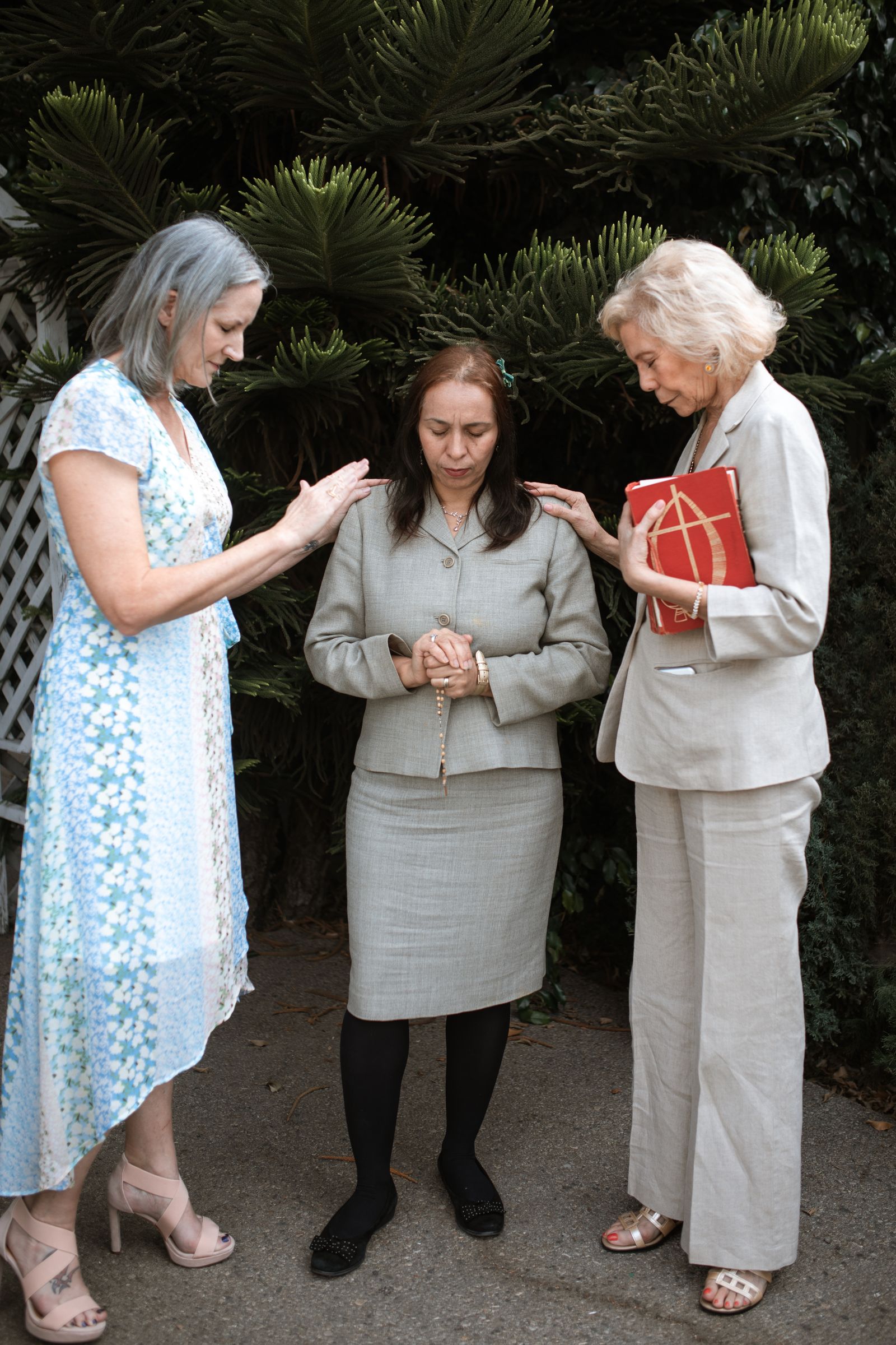 Two women sitting together as one comforts her friend