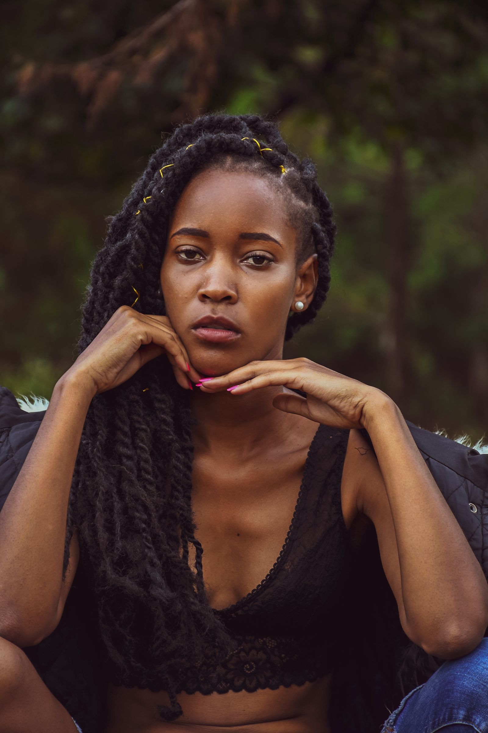 A thoughtful Black woman outdoors reflecting on her story and future