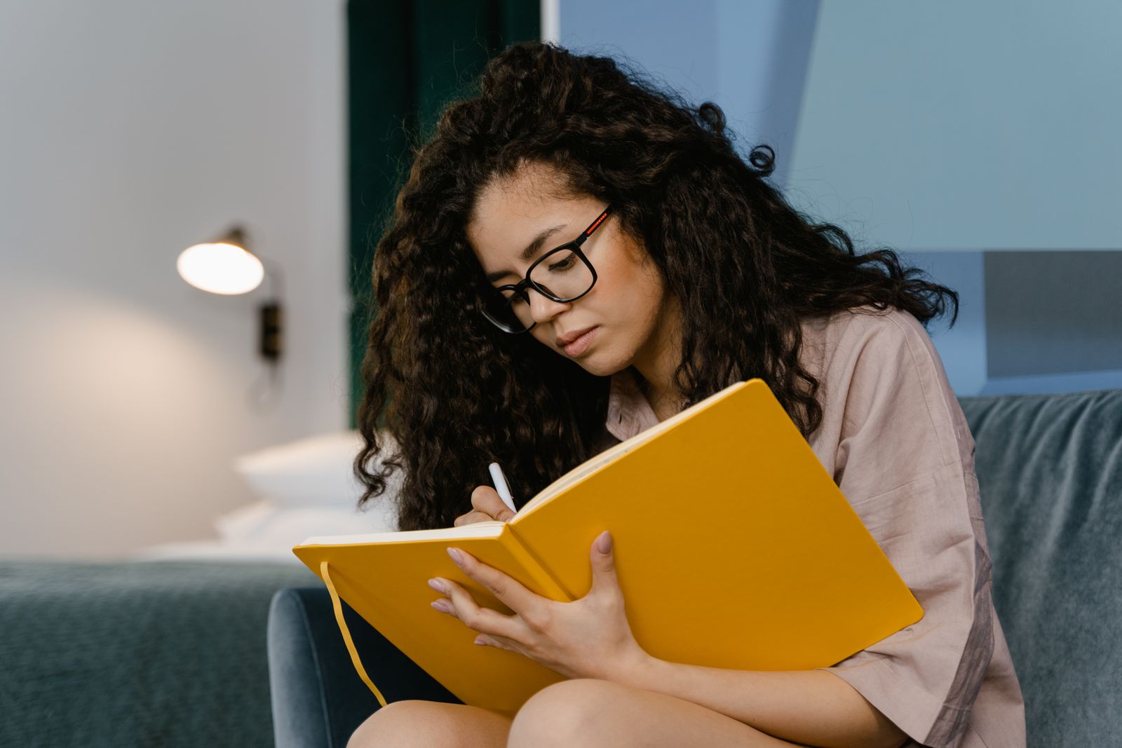 A woman writing reflections in a notebook