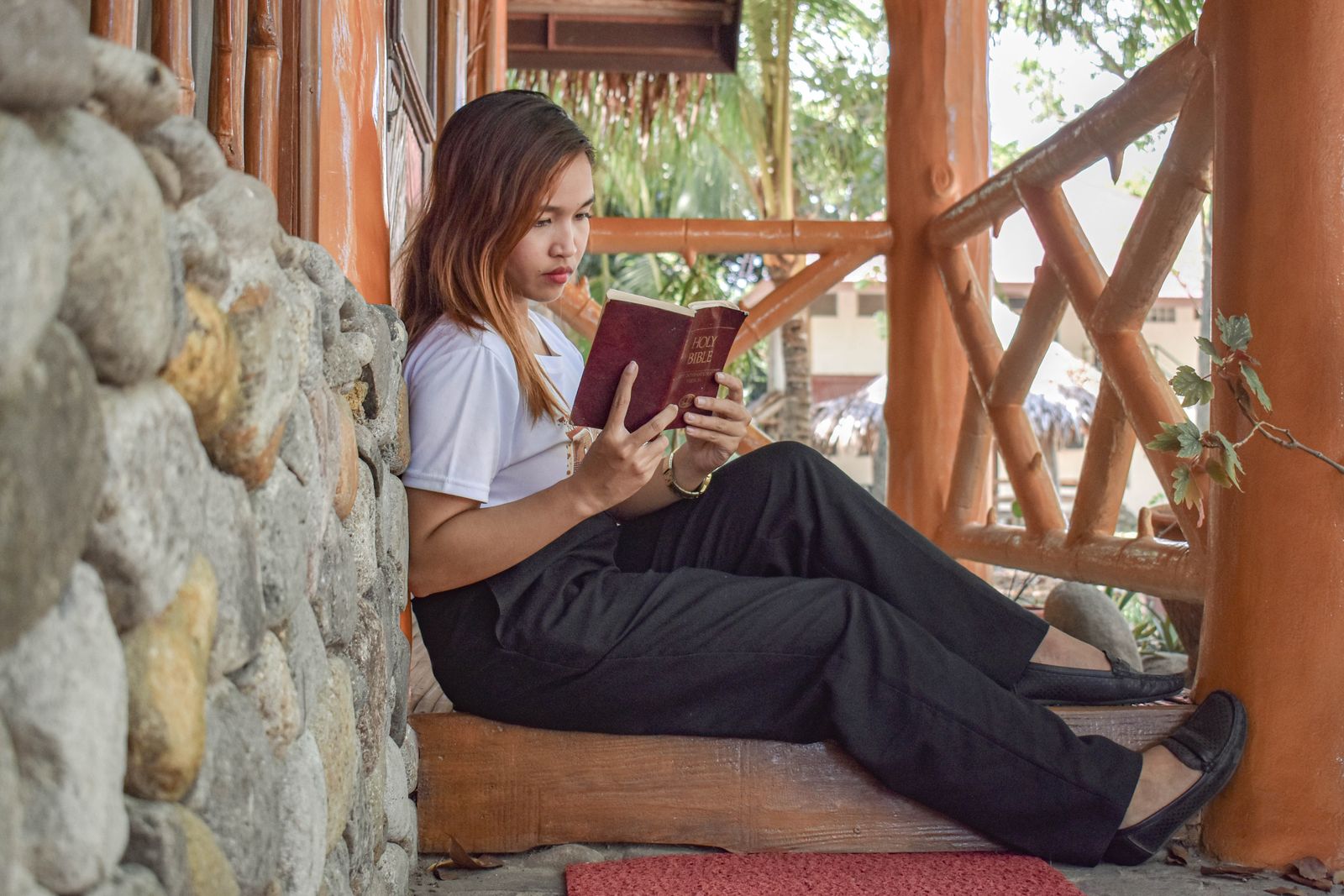 A woman quietly reading and reflecting on Scripture outdoors